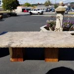 Travertine table with hammered edge, wooden block legs