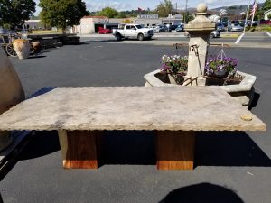 Travertine table with hammered edge, wooden block legs